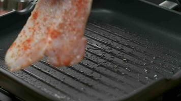 Close up professional chef grilling chicken fillet. Slow motion video