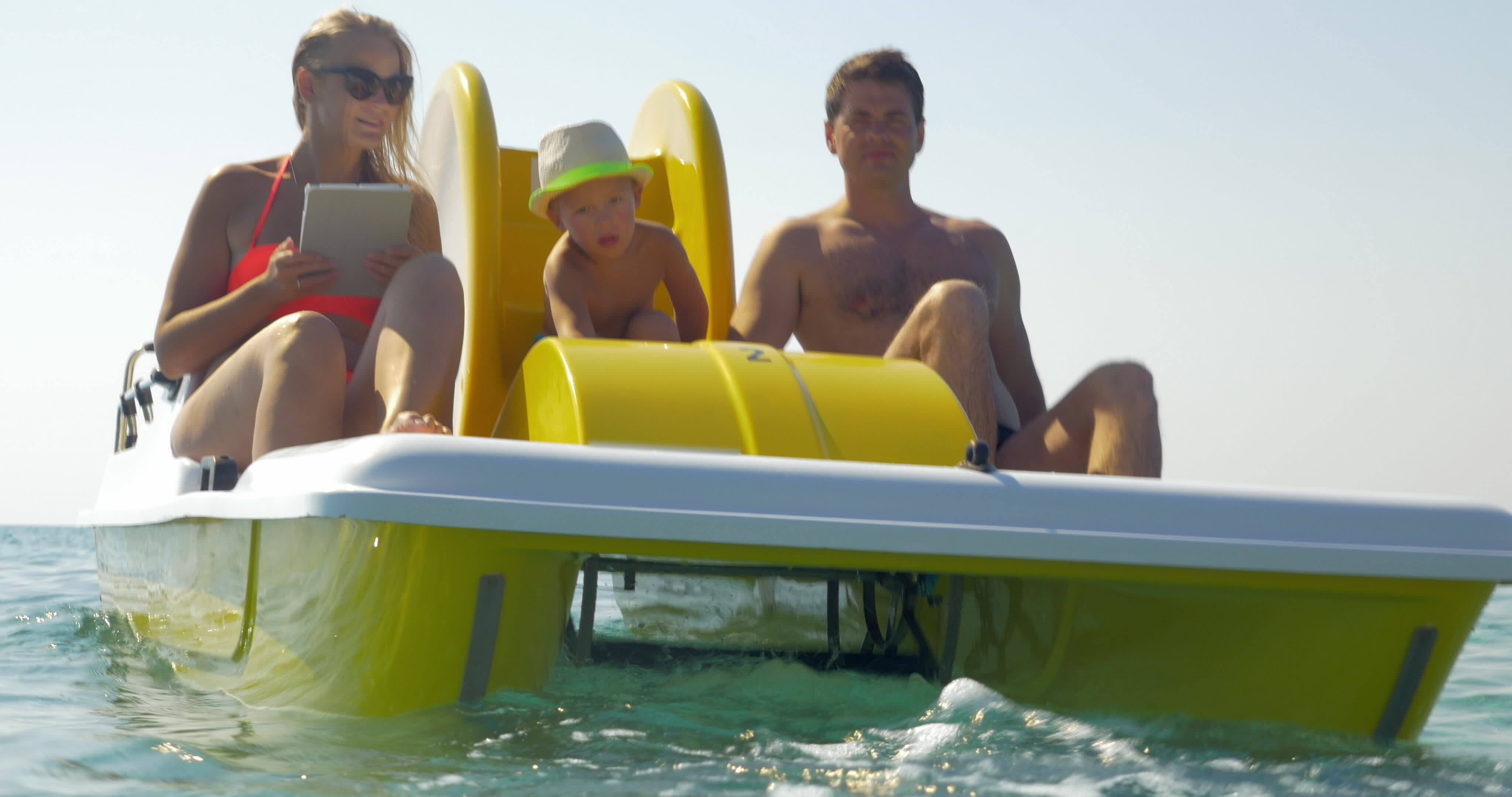 Family of three enjoying water ride on pedal boat 29045411 Stock Video at  Vecteezy