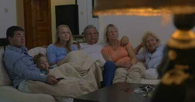 Family watching movie together video