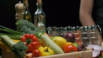 Composition of fresh whole and sliced vegetables on the table. Slow motion video