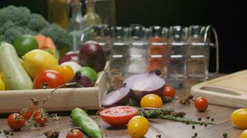 Composition of fresh whole and sliced vegetables on the table. Slow motion video