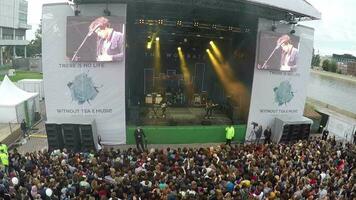 Outdoor rock concert on riverside, aerial view video