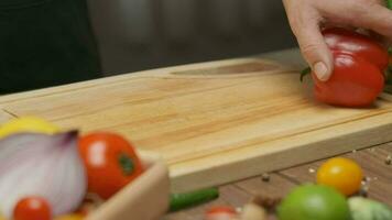 Professional chef prepares and cuts red bell pepper. Close up slow motion video