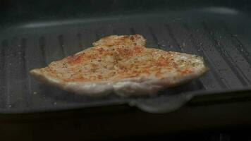 Close up professional chef grilling chicken fillet. Slow motion video