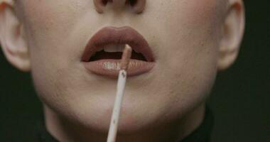 Young elegant woman applies gloss to her lips. Close Up, slow Motion, Studio Shot. video