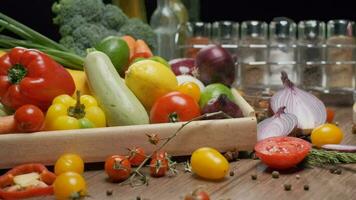 Composition of fresh whole and sliced vegetables on the table. Slow motion video