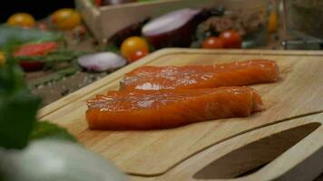 dos filete Listo rebanadas de salmón en el corte tablero. cerca arriba lento movimiento video