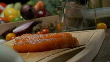 Two steak ready slices of salmon on the cutting board. Close up slow motion video
