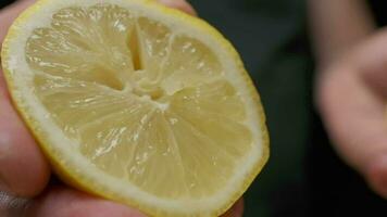 Professional chef squeezes lemon fruit slowly. Close up. video