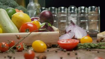 Composition of fresh whole and sliced vegetables on the table. Slow motion video