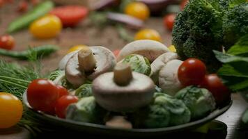 Composition of fresh whole and sliced vegetables on the table. Slow motion video