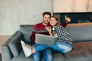 young pretty man and woman sitting at home photo
