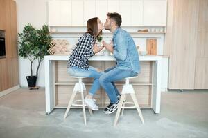 young happy man and woman in kitchen, breakfast, couple together in morning photo