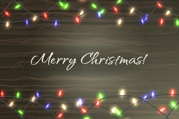 Christmas colorful string lights on wooden background
