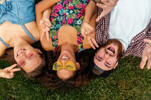 happy young company of friends sitting park photo