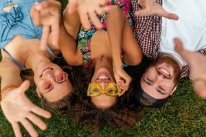 happy young company of friends sitting park photo