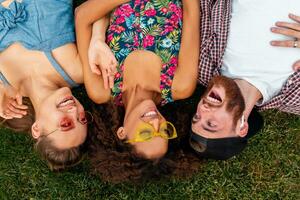 happy young company of friends sitting park photo