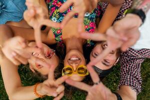 happy young company of friends sitting park photo