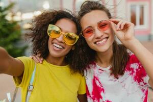 happy young girls friends smiling in street photo