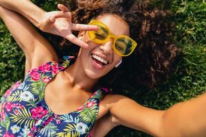 young stylish black woman having fun in park summer fashion style photo