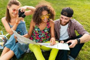 happy young company of friends sitting park photo