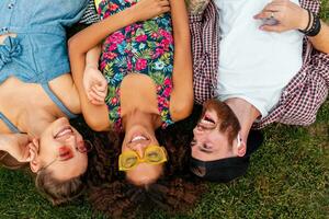 happy young company of friends sitting park photo