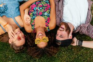 happy young company of friends sitting park photo