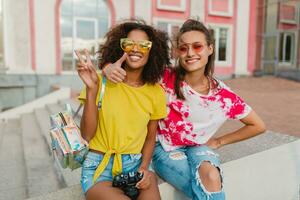 happy young girls friends smiling sitting in street photo