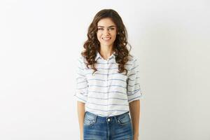 attractive young woman dressed in casual student style, shirt and jeans, curly hair, smiling, looking in camera, beautiful model isolated on white studio background, white teeth, pretty face photo