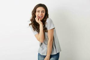 emotional positive young woman laughing sincerely, natural look, smiling happy, curly hair, face expression, posing on white studio background isolated, summer casual style, white teeth, hipster style photo