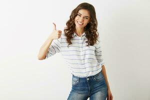 portrait of young attractive woman dressed in casual outfit shirt and jeans showing positive gesture, smiling, happy, hipster style, isolated, curly, thumb up, slim, beautiful, looking in camera photo