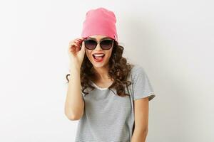 portrait of hipster pretty woman in pink hat, sunglasses, smiling, happy mood, isolated, funny, casual style, t-shirt, summer fashion outfit photo