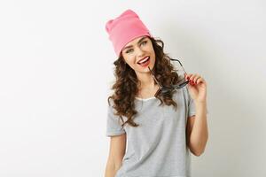 close up portrait of young hipster pretty woman in pink hat, holding sunglasses, smiling, happy mood, isolated, sexy, flirty, looking in camera, curlu hair photo