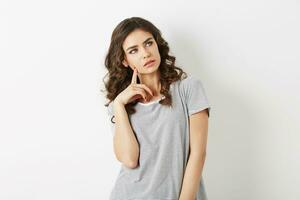 close up portrait of young pretty woman thinking, looking up, having a problem, beautiful face, isolated on white studio background, idea, student, photo