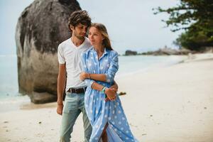 young stylish hipster couple in love on tropical beach photo