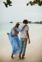 young stylish hipster couple in love on tropical beach photo