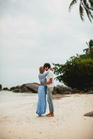 young stylish hipster couple in love on tropical beach photo