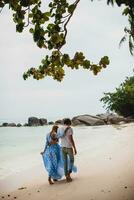 young stylish hipster couple in love on tropical beach photo