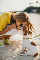 young stylish hipster woman holding walking playing dog photo