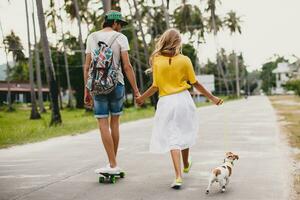 young stylish hipster couple in love on vacation with dog and skateboard photo