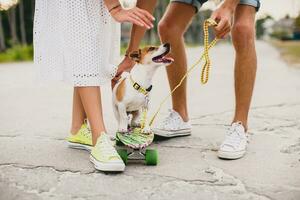 young stylish hipster couple in love on vacation with dog and skateboard, photo