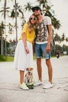 young stylish hipster couple in love on vacation with dog and skateboard, photo