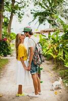 young stylish hipster couple in love on vacation with dog photo