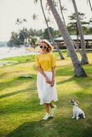 young stylish hipster woman holding walking playing dog puppy jack russell photo