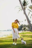 young stylish hipster woman holding walking playing dog puppy jack russell photo