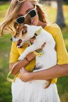 young stylish hipster woman holding walking playing dog puppy jack russell photo