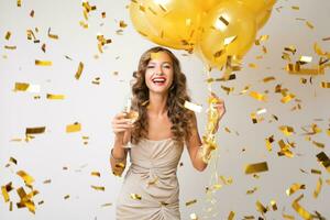pretty woman celebrating party in golden confetti photo