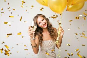 pretty woman celebrating party in golden confetti photo