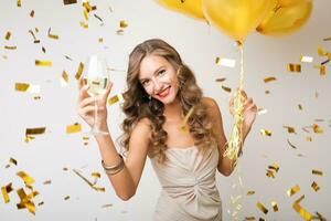 pretty woman celebrating party in golden confetti photo