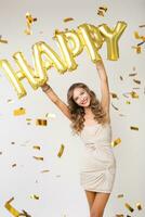 pretty woman celebrating party in golden confetti photo